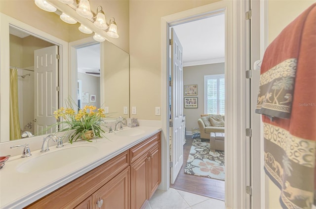 bathroom featuring vanity, tile patterned flooring, and crown molding