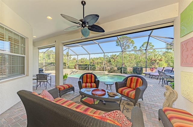 view of patio / terrace featuring a lanai, outdoor lounge area, and ceiling fan