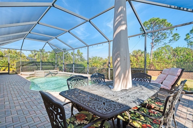 view of patio featuring a swimming pool with hot tub and glass enclosure