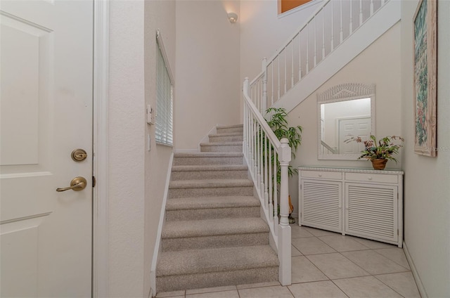 stairway with tile patterned floors