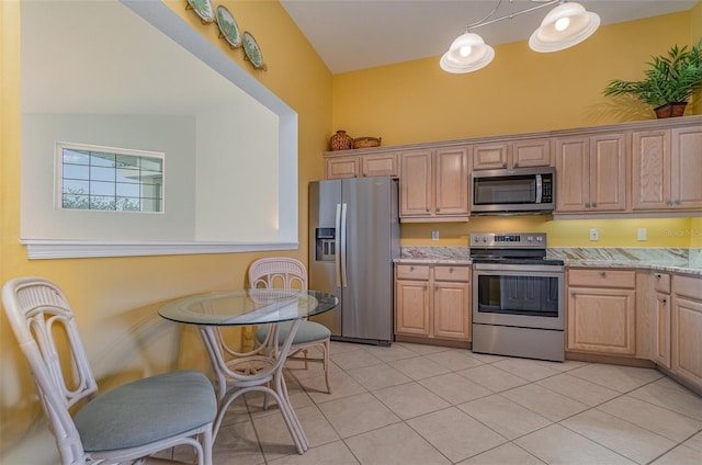 kitchen with appliances with stainless steel finishes, pendant lighting, light brown cabinetry, and light tile patterned floors