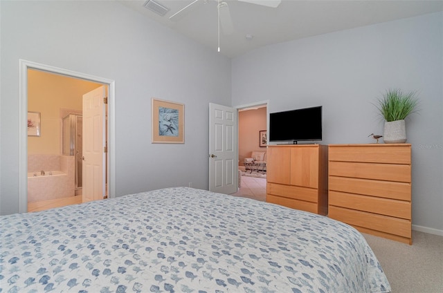 bedroom with light carpet, connected bathroom, and ceiling fan