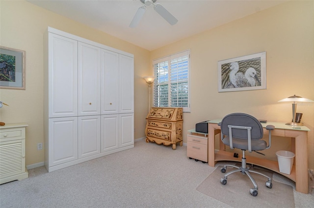 carpeted office space with ceiling fan