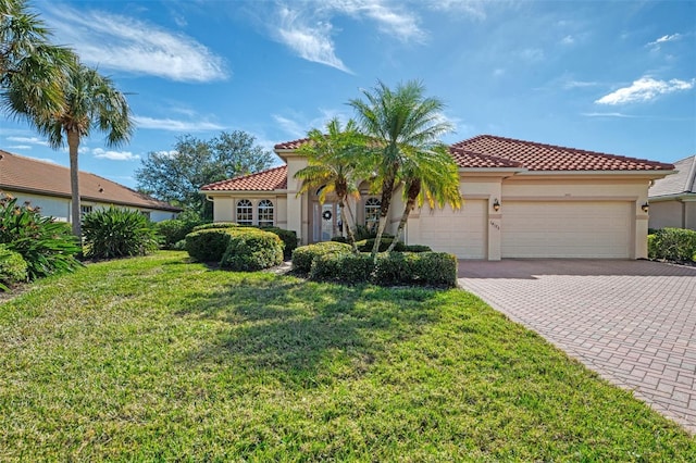 mediterranean / spanish home with a garage and a front lawn