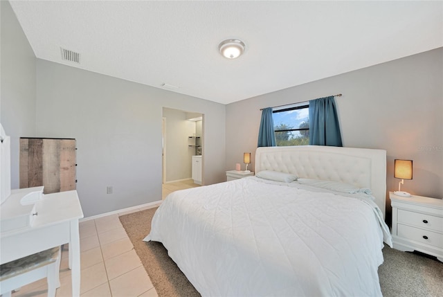 bedroom with light tile patterned floors