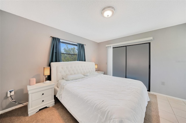 tiled bedroom with a closet