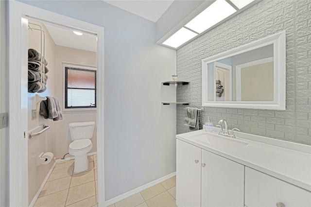 bathroom featuring vanity, toilet, and tile patterned flooring