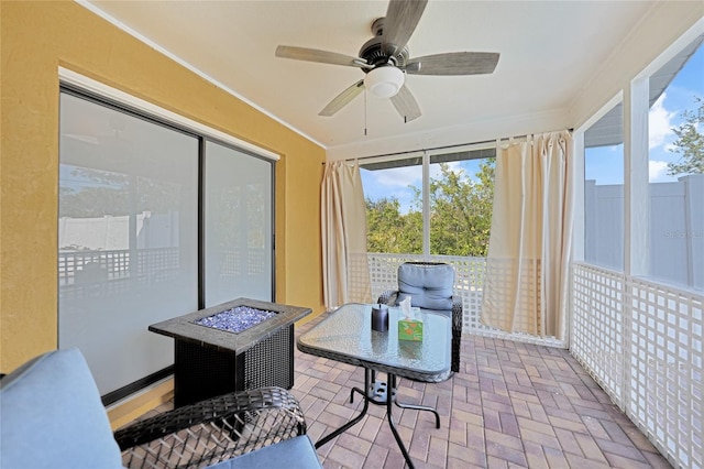 sunroom featuring plenty of natural light and ceiling fan