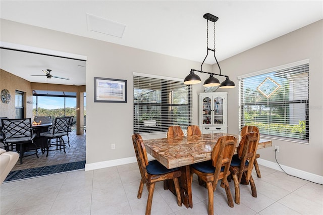 tiled dining room featuring ceiling fan