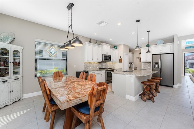 tiled dining room with sink