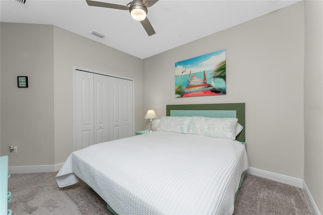 bedroom featuring light colored carpet, a closet, and ceiling fan