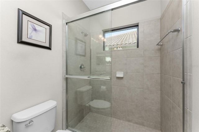 bathroom featuring an enclosed shower and toilet