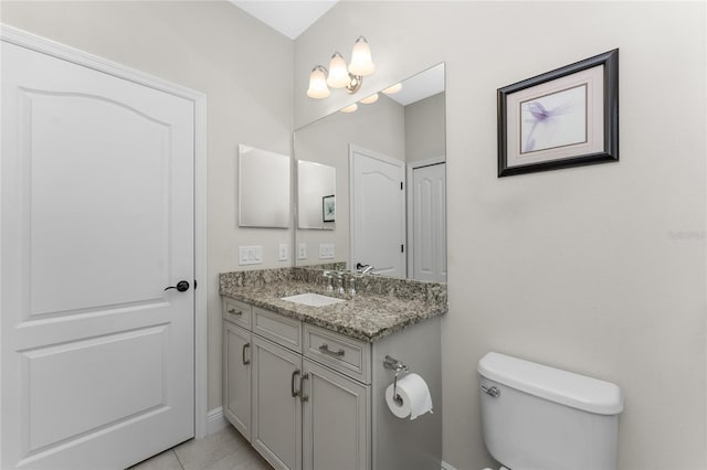 bathroom featuring vanity, tile patterned floors, and toilet