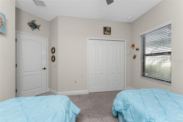 carpeted bedroom featuring a closet and ceiling fan