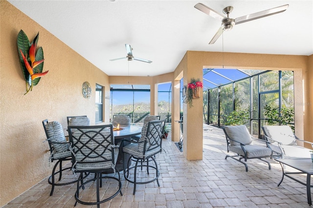 sunroom / solarium featuring a wealth of natural light and ceiling fan