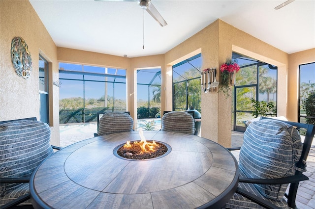 sunroom / solarium with a wealth of natural light and ceiling fan