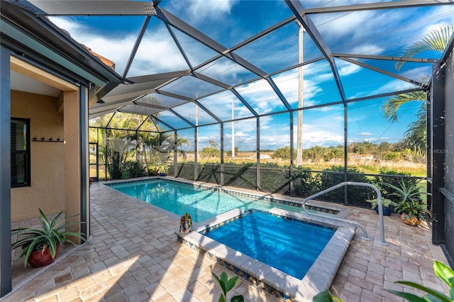 view of pool featuring a lanai, a patio, and an in ground hot tub