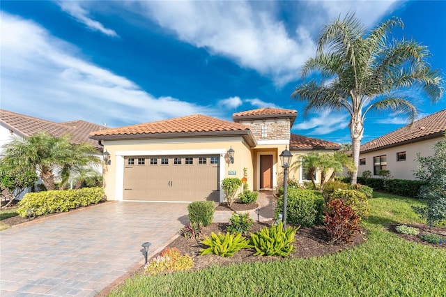 mediterranean / spanish-style home with a garage