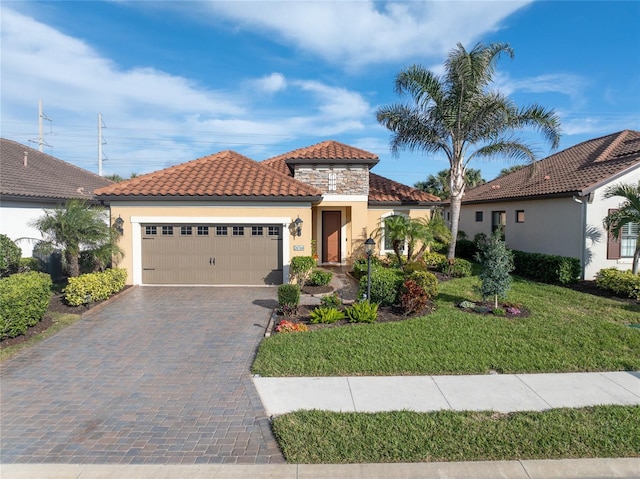 mediterranean / spanish-style home featuring a garage and a front lawn