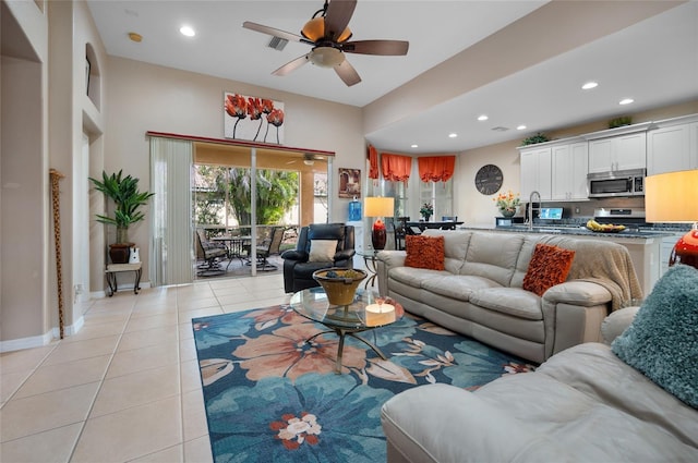 living room with light tile patterned floors, sink, and ceiling fan