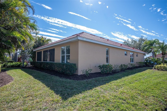 view of home's exterior with a lawn