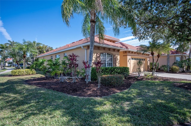 view of front of home with a garage and a front lawn