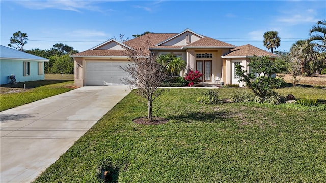 view of front of home featuring a garage and a front yard