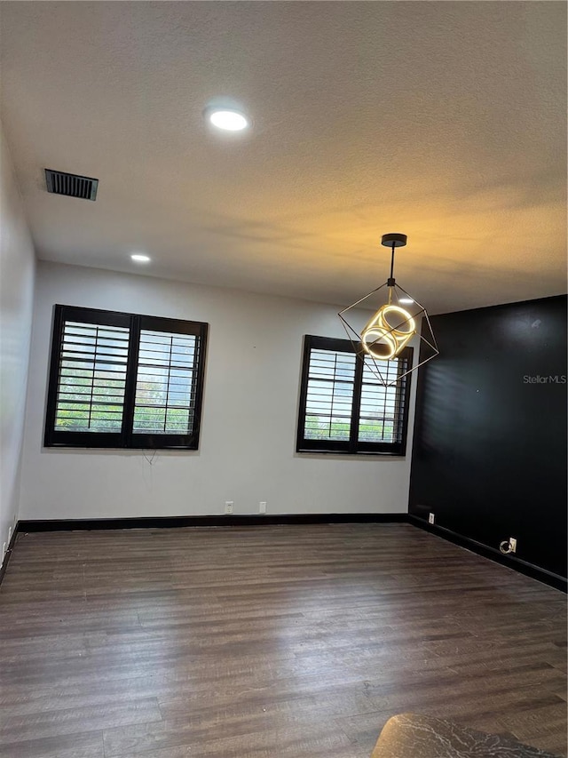 spare room with dark wood-type flooring