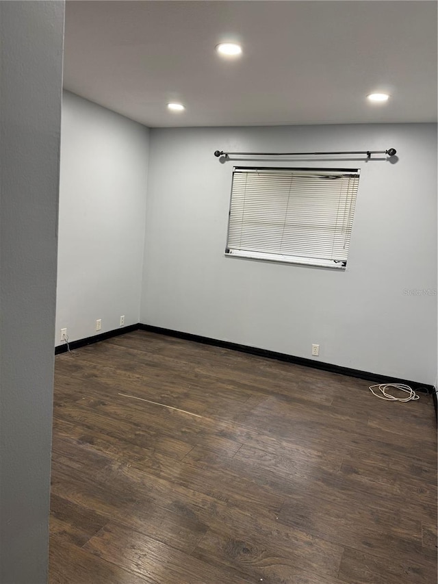 spare room featuring dark hardwood / wood-style flooring