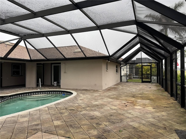 view of pool with a patio and glass enclosure