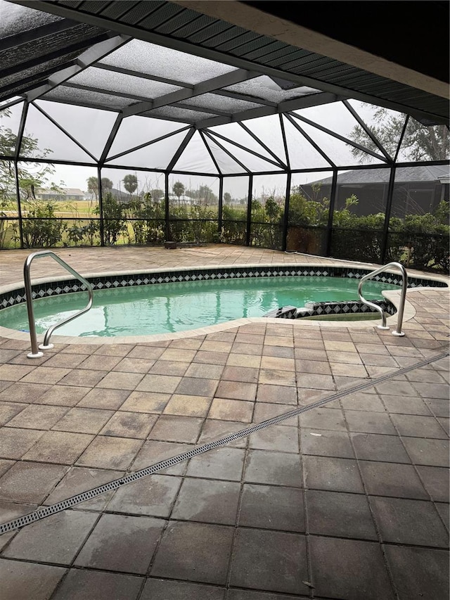 view of pool with a lanai and a patio