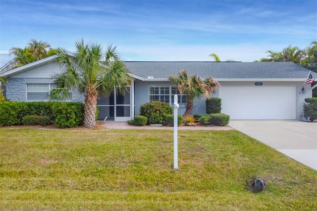 ranch-style house featuring a garage and a front yard