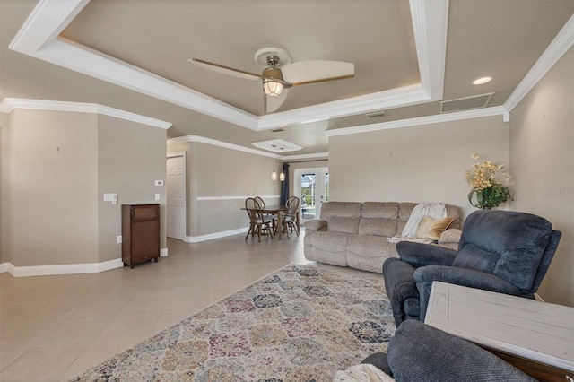 living room featuring crown molding, ceiling fan, a raised ceiling, and light tile patterned floors