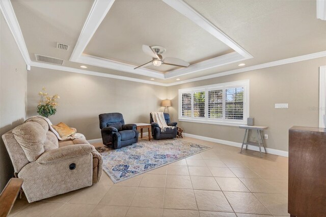 living area featuring a raised ceiling, crown molding, and light tile patterned floors