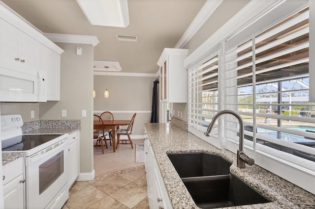 kitchen featuring sink, ornamental molding, white appliances, light stone countertops, and white cabinets