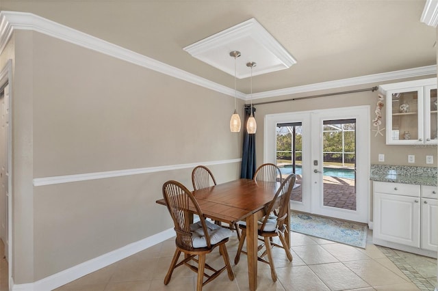 dining room with crown molding, french doors, and light tile patterned flooring