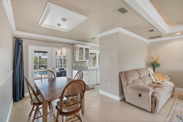 dining space featuring light tile patterned floors, crown molding, and french doors