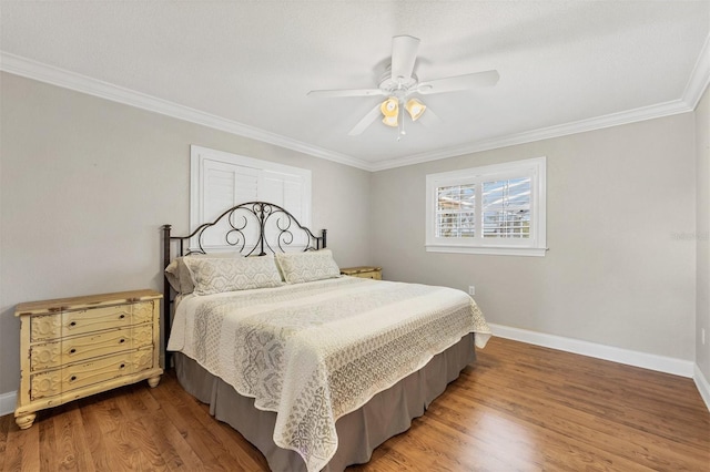 bedroom featuring crown molding, ceiling fan, and wood-type flooring