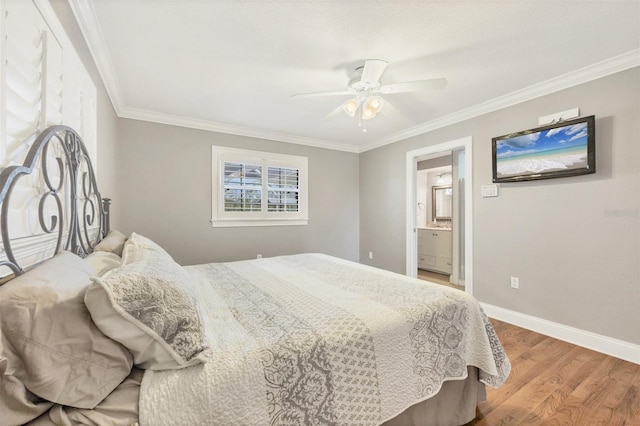 bedroom with hardwood / wood-style flooring, ceiling fan, ornamental molding, and connected bathroom