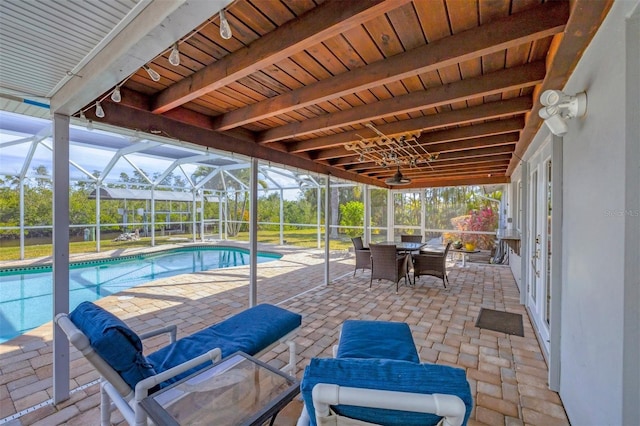 view of swimming pool with a lanai and a patio area