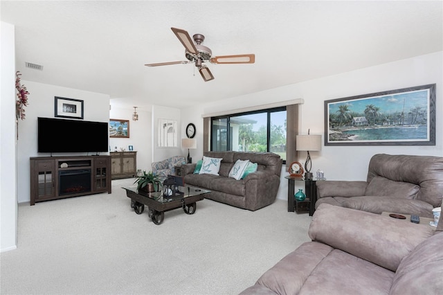 carpeted living room with ceiling fan