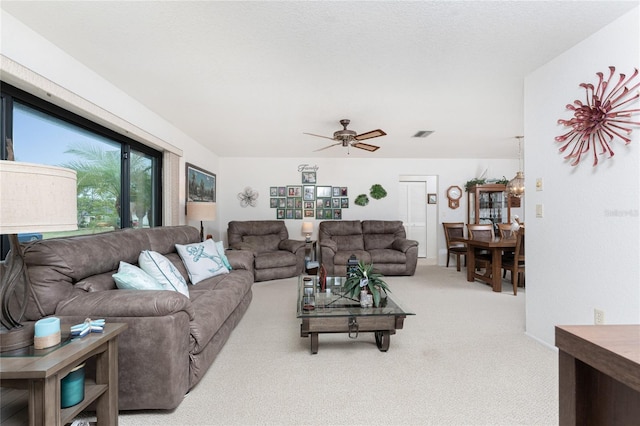 living room featuring carpet floors and ceiling fan