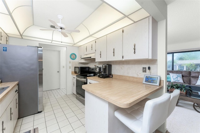 kitchen with white cabinetry, ceiling fan, appliances with stainless steel finishes, and kitchen peninsula