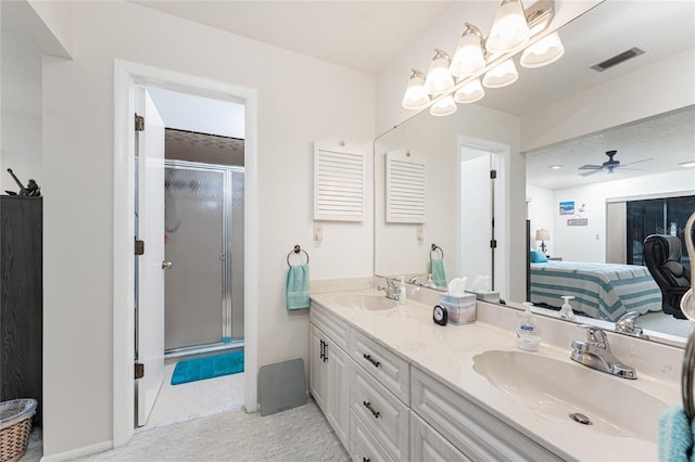 bathroom featuring vanity, ceiling fan, and walk in shower