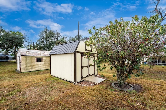 view of outbuilding featuring a lawn