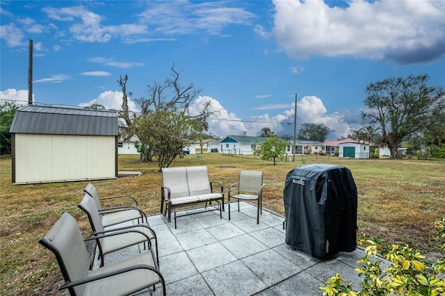 view of patio featuring a grill and a storage unit