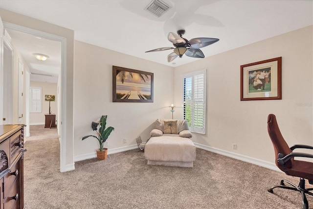 office area with light carpet, baseboards, visible vents, and ceiling fan