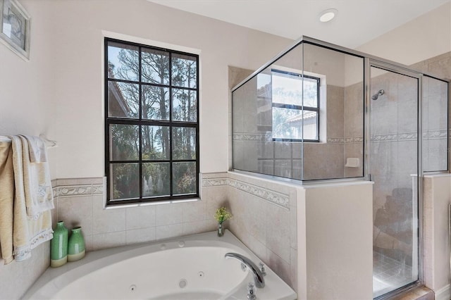 bathroom featuring a stall shower and a jetted tub