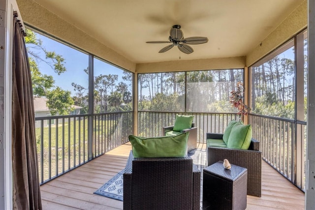 sunroom featuring a ceiling fan