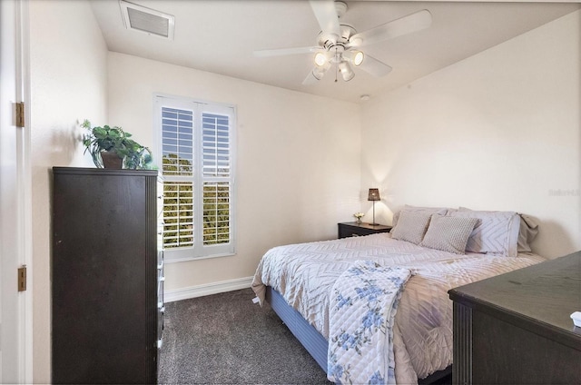 bedroom with dark colored carpet, visible vents, ceiling fan, and baseboards